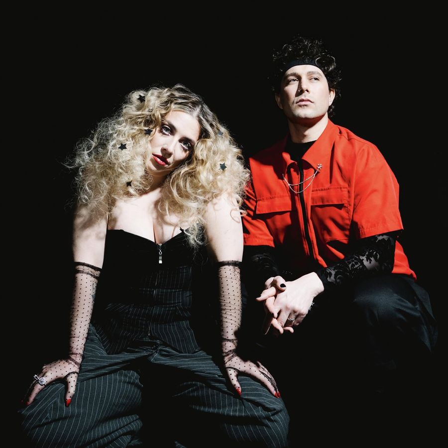 Vukovi, a duo, posed against a black background